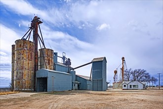Silos connected to a grain elevator on a farm near the village Melrose in Curry County