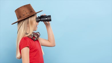 Side view girl looking with binocular