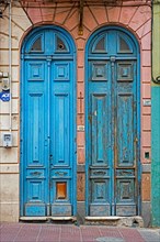 Two blue narrow front doors of colonial houses in the Ciudad Vieja