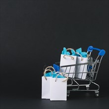 Toy shopping trolley with gifts packets