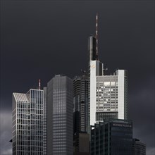 Commerzbank Tower in the light in front of dramatically dark clouds