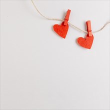 Two red hearts string with pins