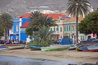 Traditional colourful wooden fishing boats on the beach along the waterfront of the old colonial historic center of the city Mindelo on the island Sao Vicente