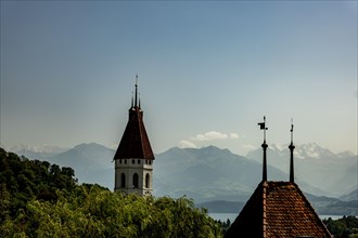 Church Tower with Lake and Mountain View and Blue Clear Sky in a Sunny Day in Thun