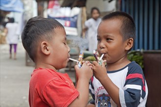 Indonesian children as young as three are being taught how to smoke by being allowed to puff away on home-made pipes called Popeye Lauts