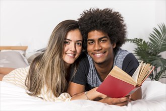 Portrait interracial couple reading together