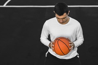 Portrait man holding basketball