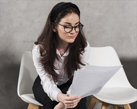 Woman reading her resume before attending job interview