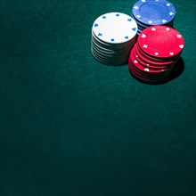 Stack casino chips green table