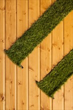 Wooden background with artificial grass