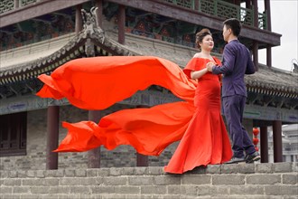 Wedding couple standing on the city wall in Xian