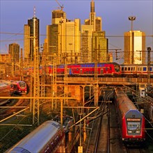 Elevated city view in the evening light with many trains