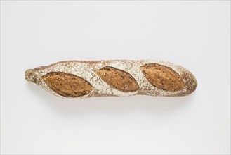 Whole rustic baked baguette white background