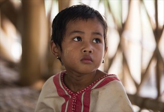 Close up portrait of Burmese child of the Bamar tribe in Kayin village near Hpa-an