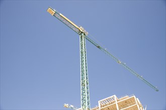 Low angle view construction site against blue sky