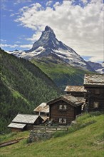 Traditional wooden chalets of the Alpine village Findeln with view over the Matterhorn mountain