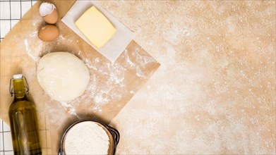 Oil bottle flour butter block eggs ball dough kitchen counter