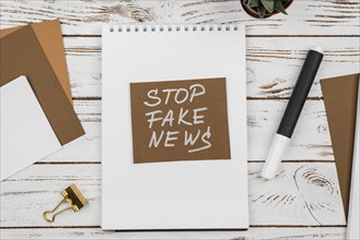 Stop fake news concept top view