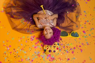 Top view cute girl with clown wig confetti