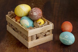 High angle colorful eggs easter wooden crate