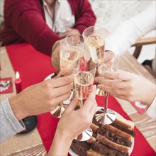 People clanging glasses champagne festive table