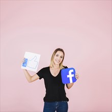 Portrait happy woman with facebook thumbs up icon