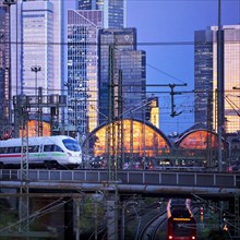 Elevated city view with trains to the main railway station with skyscrapers at dusk