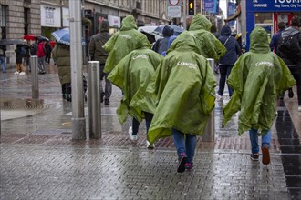 Tourists cross the street in downtown Dublin in a very rainy day in the capital city. Dublin
