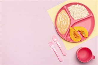 Top view baby food with fruit cutlery