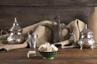 Turkish delight with teapots wooden table