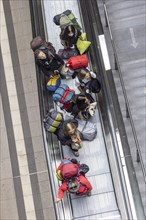 Escalator and stairs and railway travellers