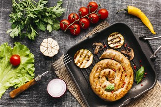 Grilled snail sausages pan with spices vegetable wooden grey backdrop
