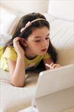 Side view girl paying attention her tablet