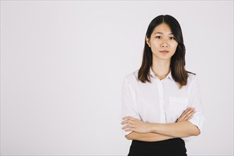 Young businesswoman with arms crossed
