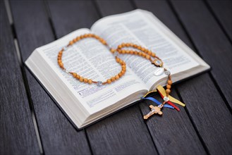 Open Bible translation of the Old and New Testament with olive wood rosary