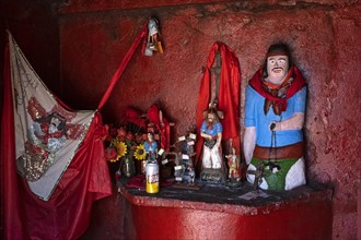 Traditional red roadside shrine to folk saint Gauchito Gil