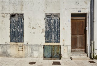 Old facade with shutters and door in Le Chateau-d'Oleron