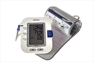 Close up of digital blood pressure monitor on white background
