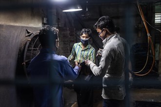 Workers colouring jeans in a textile factory