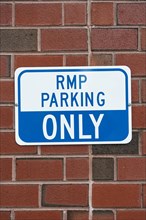 Parking sign brick wall closeup