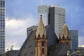 Old Catholic church of St Leonhard in front of modern skyscrapers