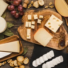 Piece natural cheeses cheese board with tasty ingredient wooden desk