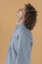 Side view portrait curly haired young man