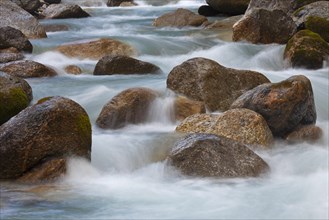 Water flowing over boulders in Alpine mountain stream in the Alps