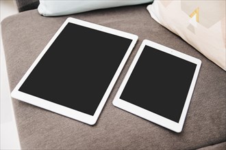 Close up two digital tablets with black screen