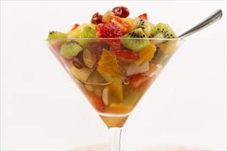 Fresh summer fruit salad on a white background