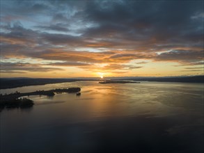 Aerial view of western Lake Constance at sunrise with the Mettnau peninsula and the island of Reichenau on the horizon