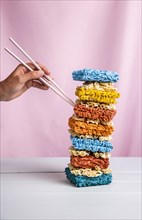 Front view tower colorful ramen hand with chopsticks