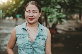 Portrait of Latin American girl face looking and smiling at the camera. Portrait of young Nicaraguan woman smiling at camera. Portrait of attractive latin girl smiling outdoors