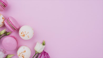 Flat lay macarons with roses copy space